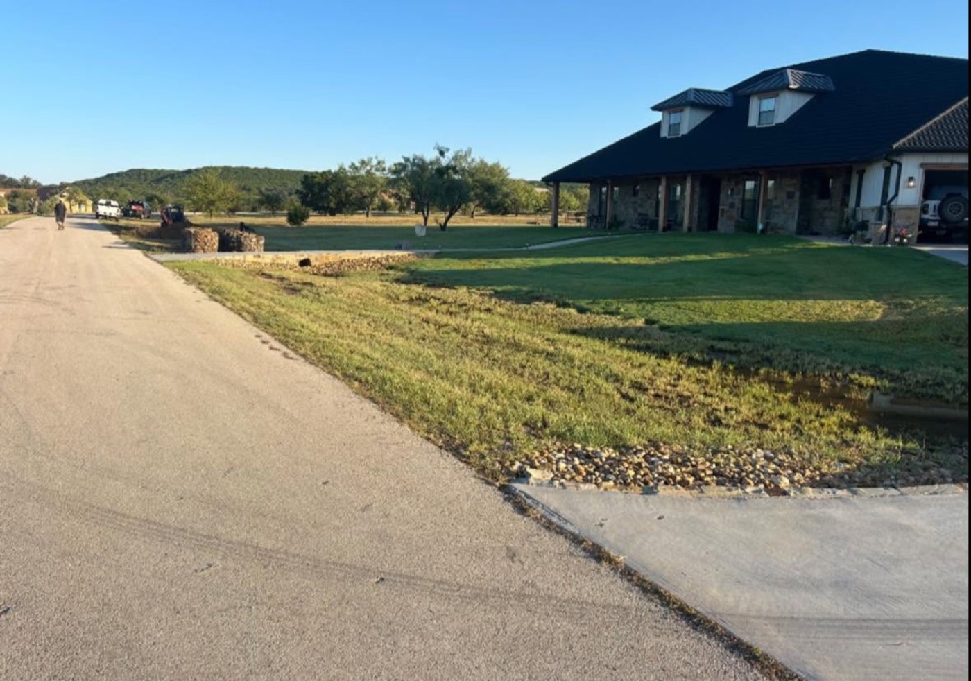 Before: unfinished driveway and yard at a home