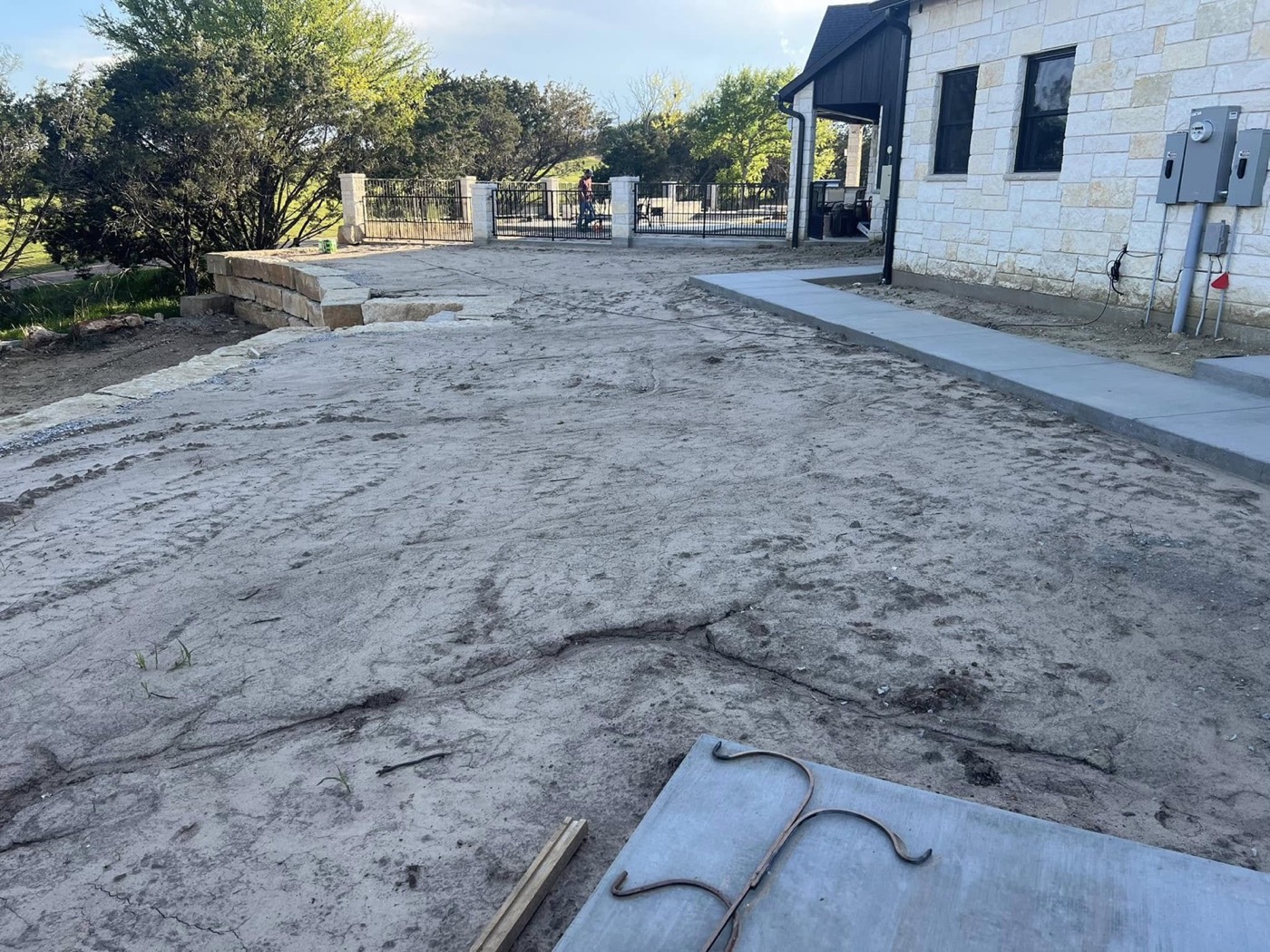 Before: unfinished driveway and landscape area at the home