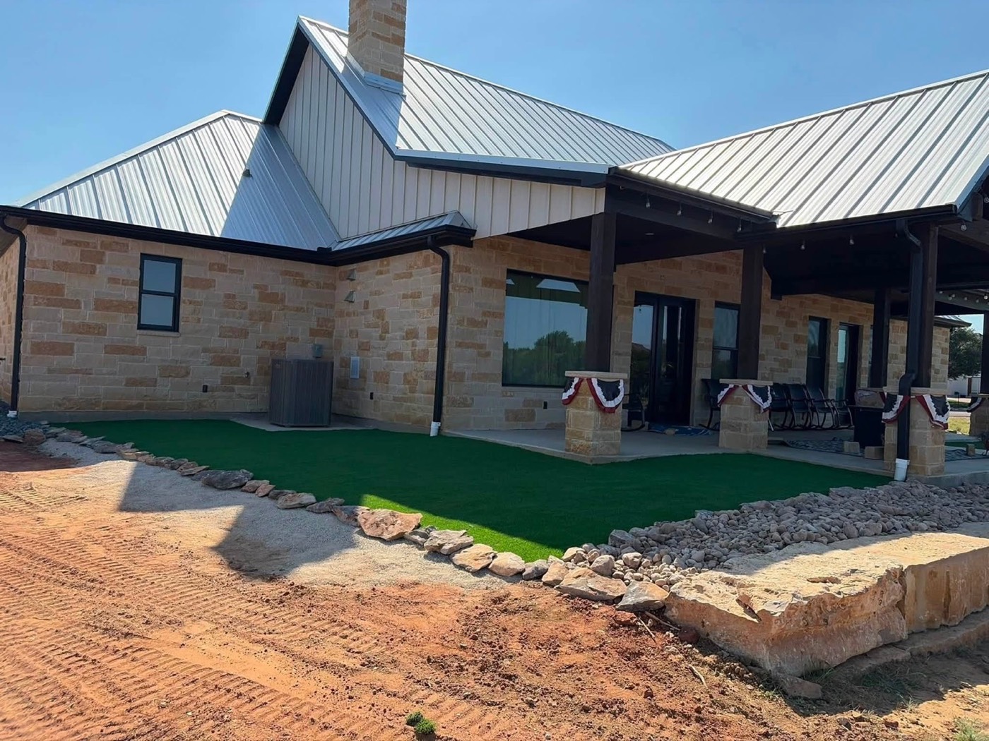 Stone-edged turf and rock landscaping at a home